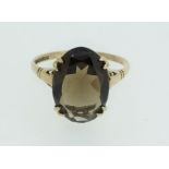 A 9ct gold ring set with central smoky quartz, size R, 2.5g