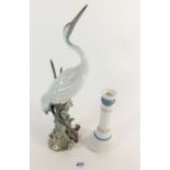 A Lladro crane, 29cm high and a similar candlestick