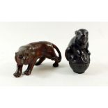 A pair of carved wooden netsuke in the form of a lion and a rabbit, both signed