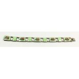 A silver plated and enamel green and floral bracelet by K & F