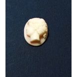 A 19th century pink hardstone small cameo of a woman, 1.5cm tall