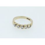 A 9 carat gold ring set five diamonds in scrollwork setting, size L