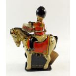 A tin plate clcokwork guardsman cavalry drummer, with key