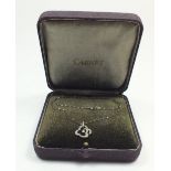 An antique silver Carnet pendant set chip diamond, boxed