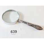 A silver handled magnifying glass
