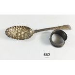 A silver Georgian berry spoon and a silver napkin ring