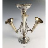 An antique silver epergne with central vase and three removable tapered vases on a circular weighted