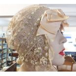 A 19th century continental lace brides headdress applied silk ribbon rosebuds