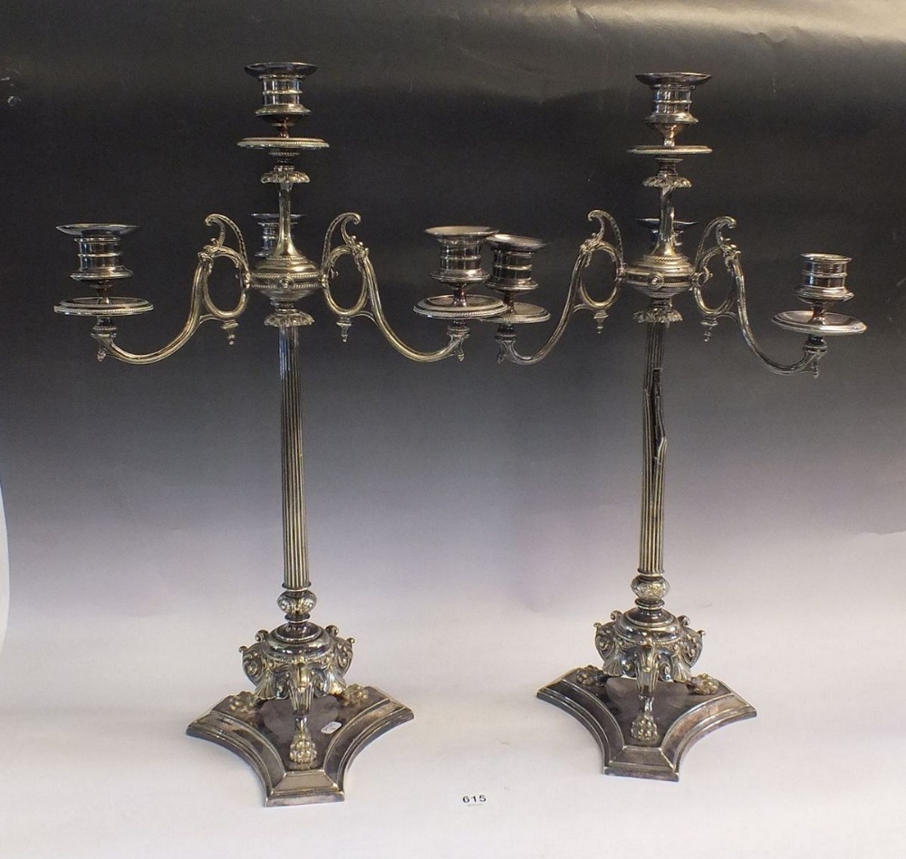 A pair of Victorian silver plated candelabra with reeded column and triple scrollwork paw