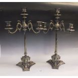 A pair of Victorian silver plated candelabra with reeded column and triple scrollwork paw