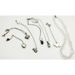 Six silver necklaces and a glass necklace