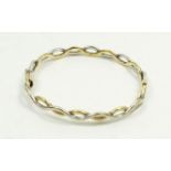 A 9 carat white and yellow gold interwoven bangle, 10g