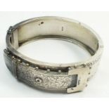 A late Victorian silver hinged buckle bracelet with engraved decoration and beadwork, diameter 5.