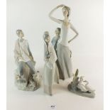 Four Nao figurines - girls holding a rabbit, boy sat with dog and sheep etc. tallest 36cm high