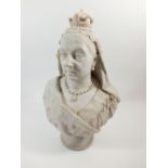 A 19th century reconstitued marble bust of Queen Victoria after J E Boehm, 1877, inset coin to base,