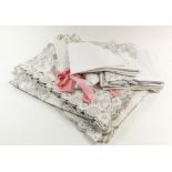 A set of eight embroidered linen place mats and runner plus another similar set, napkins etc.