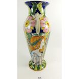 A Faience Art Nouveau studio vase painted flowers and woman's head with flowing hair, 35cm