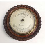 A Stuart & Mason circular barometer with carved rope design surround