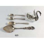 Three silver teaspoons, a silver plated preserve spoon and a white metal and glass swan