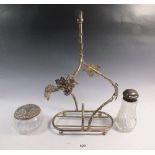 A silver plated vine form bottle holder, a cut glass and silver topped sugar caster and a cut