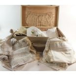 A suitcase of lace edged and embroidered table linen
