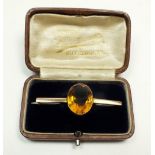 A 9ct gold bar brooch set with a large central citrine