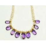 A cultured pearl necklace suspended nine amethyst drops on 18 carat gold clasp