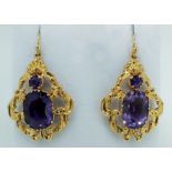 A pair of gold Victorian large pendant earrings set amethysts within scrollwork surround (with later