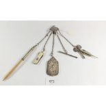 A Victorian silver chatelaine including notepad, pencils, miniature penknife etc.