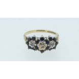 A 9 carat gold sapphire and diamond chip triple cluster ring, size N 1/2