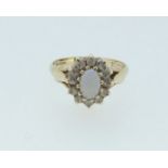A 9 carat gold opal ring within cubic zirconium, size K-L, 2.3g
