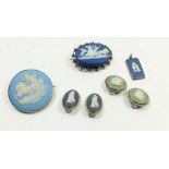 A collection of Wedgwood Jasperware jewellery to include two brooches and a silver pendant and two