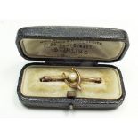 An antique 9 carat rose gold wishbone brooch set with a central pearl, fitted case, 1.4g