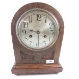 An oak Junghans arch top mantel clock with striking movmeent