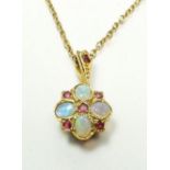 A 9 carat gold opal and ruby pendant on 9 carat gold chain