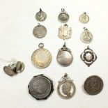 Four silver sports medals, 35g, three white metal St Christopher medallions, a locket, two Persian