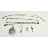 A 9 carat gold chain 5g, two gold charms, a 9 carat gold circular locket and chain etc.