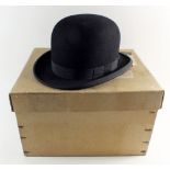 A Dunn and Co bowler hat, size 7 - boxed