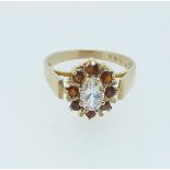 A 9 carat gold ring set white stone in garnet surround, size K to L, 2.3g