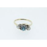 An 18 carat gold and platinum ring set blue zircon flanked by two singe cut diamonds, size L/M