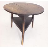 An 18th century elm topped cricket table, 75cm diameter