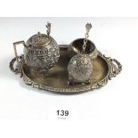 An Indian white metal cruet set