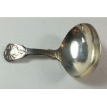 A silver fiddle pattern and shell caddy spoon, London 1814, 11g