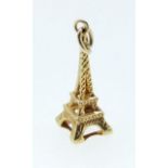 A 9 carat gold charm in the form of the Eiffel tower, unmarked but tested, 0.6g