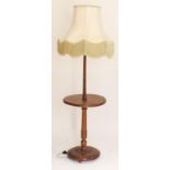 A walnut standard lamp with integral occasional table and carved base