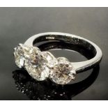 A fine three stone diamond ring set in platinum, accompanied by three GCS certificates, stating that
