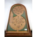 A bagatelle board in green figure of eight