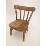 A childs stick back chair