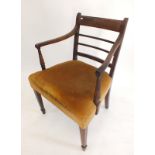 An early 19th century mahogany slat back carver chair