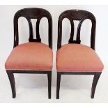 A pair of Victorian slope back chairs on sabre supports
